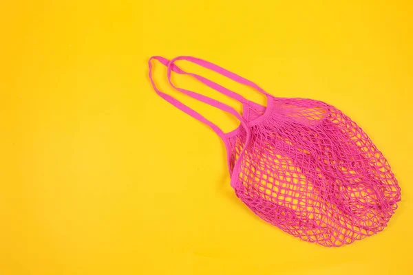 Sarı arka planda yeniden kullanılabilir alışveriş torbası. Pamuk alışveriş torbası. Sıfır atık, plastiksiz konsept. Üst manzara, düz uzanma