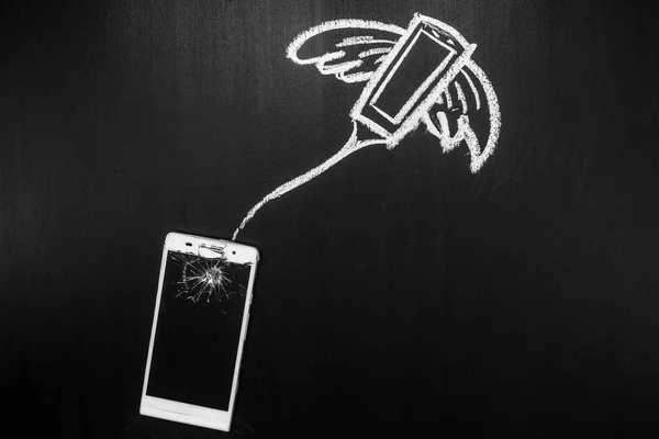Broken glass of smartphone on the black background and its soul is flying away on the heaven written by chalk