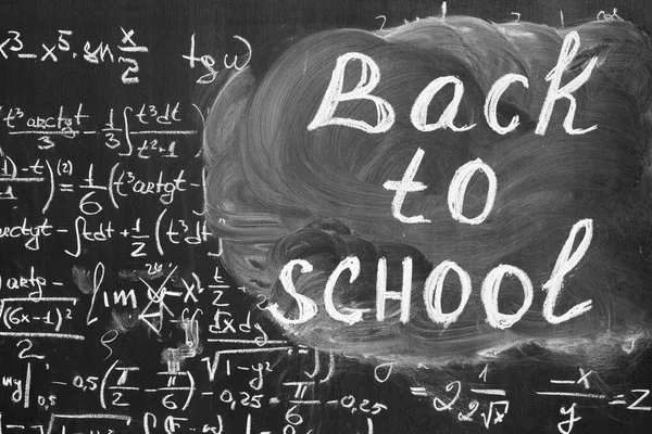 Back to school background with title "Back to school" and math formulas are written by white chalk on the black chalkboard — Stock Photo, Image