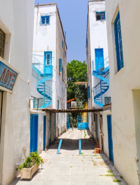 NICOSIA, CYPRUS - MAY 30, 2014 : View on the narrow street and white houses with blue iron helical stairs'