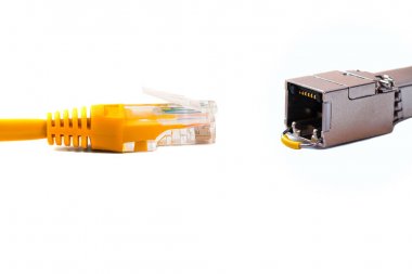 able head into (head rj45) of an ethernet wire cable or yellow patch-cord with twisted pair and SFP module,network,RJ45,plug. Isolated. Close-up clipart