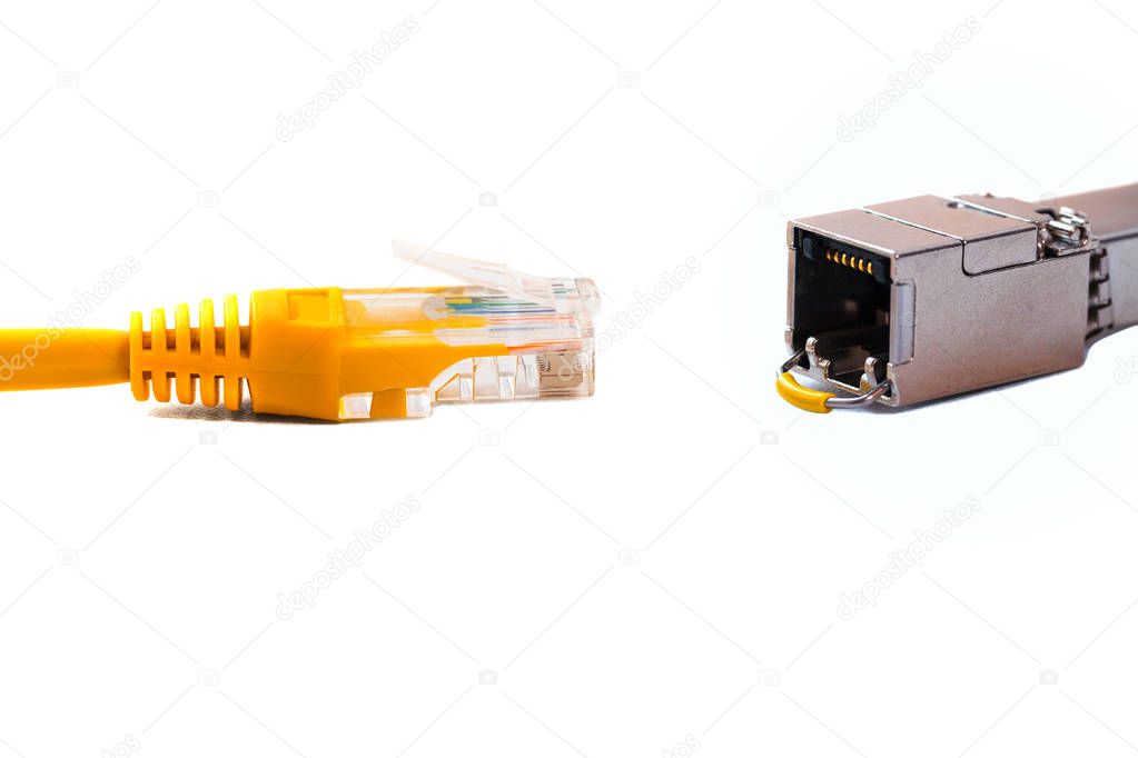 able head into (head rj45) of an ethernet wire cable or yellow patch-cord with twisted pair and SFP module,network,RJ45,plug. Isolated. Close-up