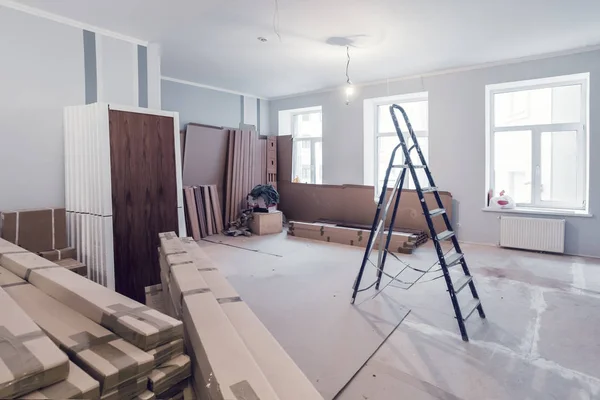 Interior del apartamento durante la construcción, remodelación, renovación, ampliación, restauración y reconstrucción - escalera y materiales de construcción en la habitación —  Fotos de Stock