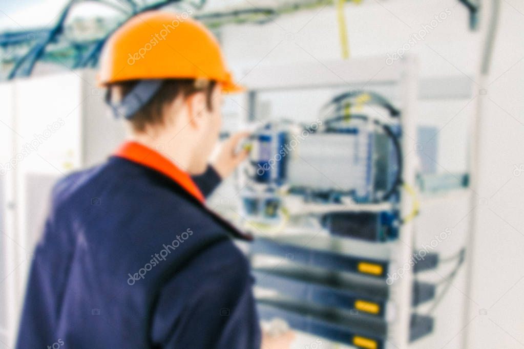 Blurred professional engineer is installing  communication equipment inside basic station of communication