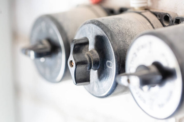 Old  voltage electrical power switches in the row. Close-up.