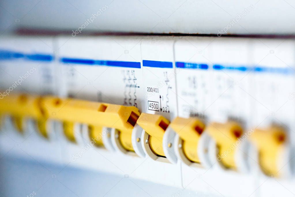 Voltage switchboard with circuit breakers are are in the ON position in the electric box. Electrical background.