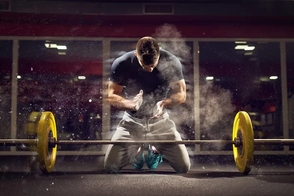 Weightlifter preparing for training. Stock Photo