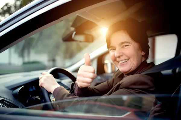 Middle aged woman driving car — Stock Photo, Image