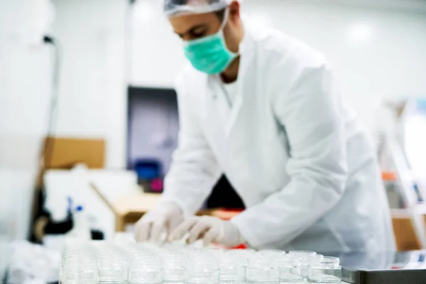 Man in gloves preparing cream — Stock Photo, Image