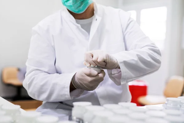 Man in gloves preparing cream — Stock Photo, Image