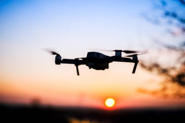 Drone flying on sunset clipart