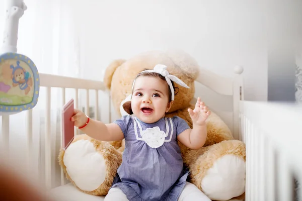 Adorable baby girl in crib — Stock Photo, Image