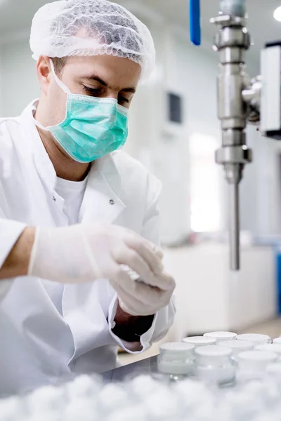 Man in gloves preparing cream — Stock Photo, Image