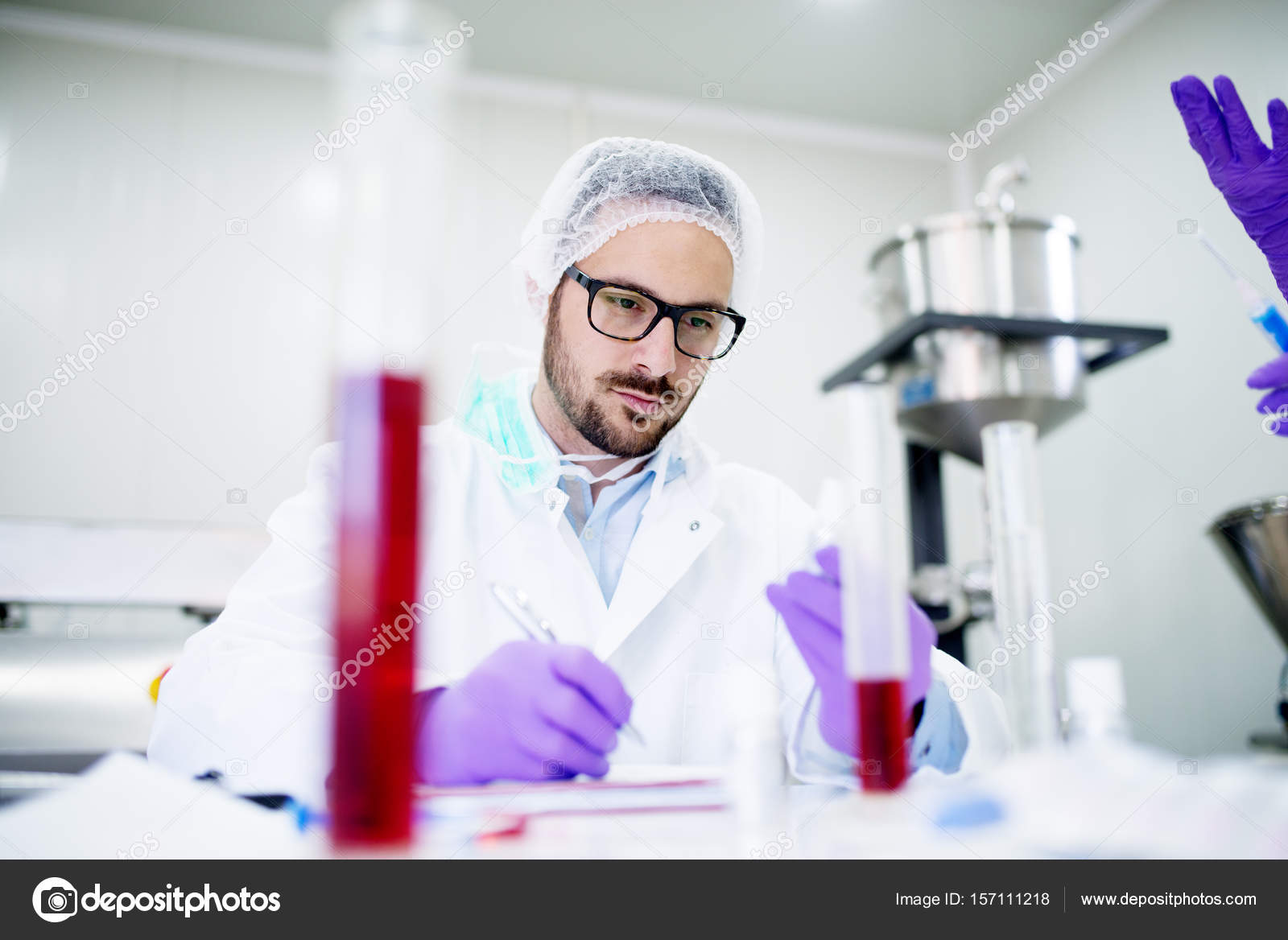 Laboratory technician doing blood analysis Stock Photo by