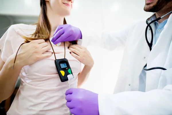 Médico verificando holter monitor cardíaco — Fotografia de Stock