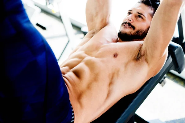 Bodybuilder working abs gym