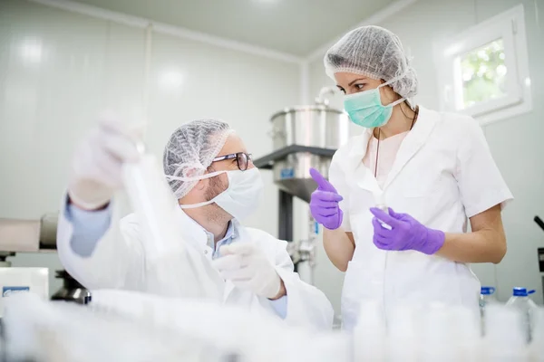 Scientists checking quality of cosmetic products — Stock Photo, Image