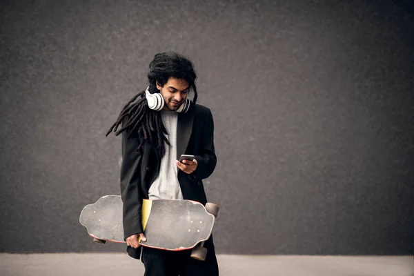 Dreadlocks ile genç şık patenci — Stok fotoğraf