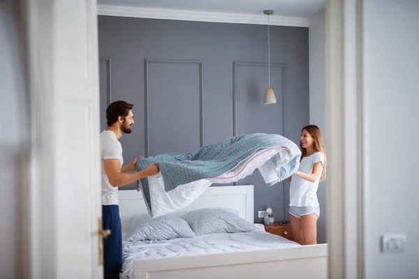 Happy Beautiful Couple Making Bed Together Having Fun Home — Stock Photo, Image