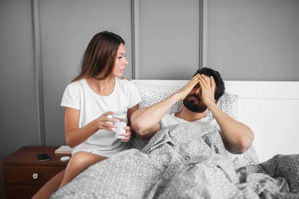 Worried Man Having Headache Lying Bed Home His Careful Girlfriend — Stock Photo, Image