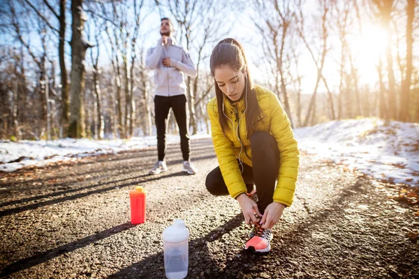 Mladá Aktivní Sportovní Žena Vázání Tkaničky Zasněžených Zimních Road Chlape — Stock fotografie