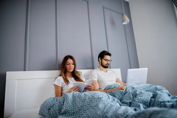 Attractive Loving Couple Relaxing Book Laptop Sleeping Home — Stock Photo, Image