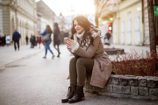 Ευτυχής Όμορφη Γυναίκα Στο Χειμερινό Παλτό Χρησιμοποιώντας Smartphone Στο Δρόμο — Φωτογραφία Αρχείου