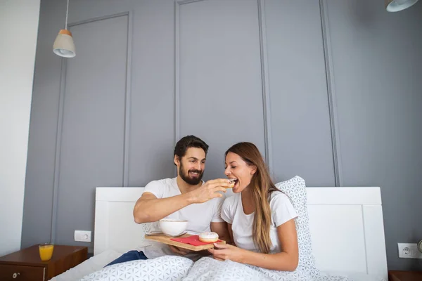 Attractive Young Happy Man Feeding Girlfriend Bed Home — Stock Photo, Image