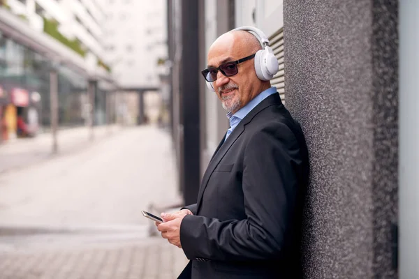 Mature Cheerful Businessman Listening Music Phone Headphones — Stock Photo, Image