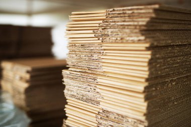  many aligned brown cardboard stacks in storage clipart