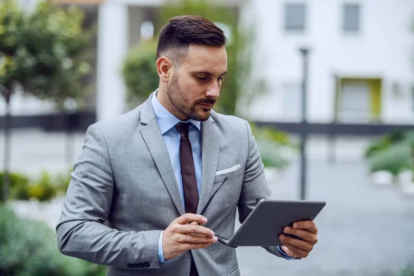 Serious Attractive Serious Businessman Suit Holding Eyeglasses Hands Using Tablet — Stock Photo, Image