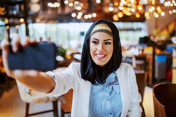 Charming Modern Smiling Muslim Woman Scarf Head Sitting Cafe Taking — Stock Photo, Image