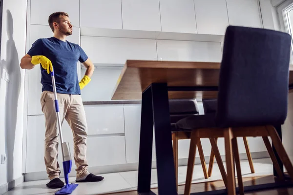 Full Length Handsome Tired Man Standing Kitchen Leaning Mop Much — Stock Photo, Image