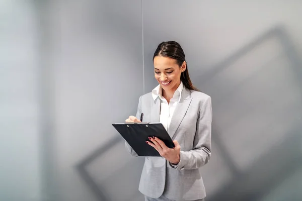 Young Attractive Caucasian Smiling Businesswoman Standing Corporate Firm Filling Documents — 스톡 사진