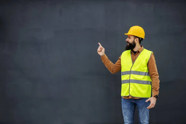 Young Smiling Bearded Worker Vest Helmet Head Standing Front Gray — 스톡 사진