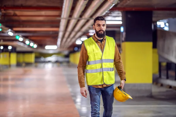 Three Quarter Length Handsome Bearded Worker Vest Holding His Safety — 스톡 사진