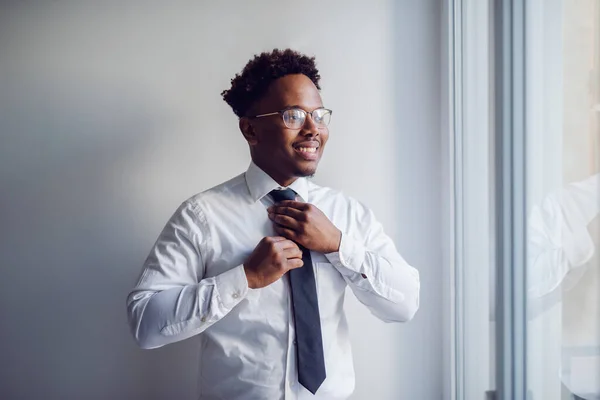 Portrait Sophisticated African American Businessman Standing Next Window Adjusting His — Stock Photo, Image