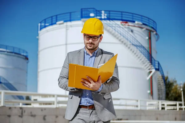 Young Dedicated Caucasian Businessman Suit Helmet Head Holding Folder Document — Stock Photo, Image