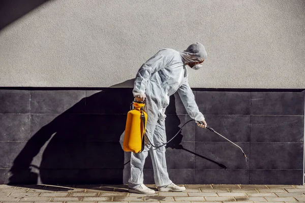 Cleaning and Disinfection outside around buildings, the coronavirus epidemic. Professional teams for disinfection efforts. Infection prevention and control of epidemic. Protective suit and mask. Professional specialist full protective cleaning outsid