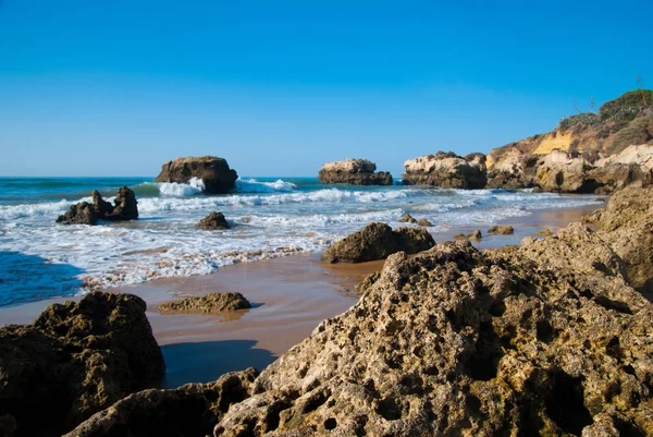野生の夏海ビーチ、ポルトガル。澄んだ空、砂の上の岩 — ストック写真