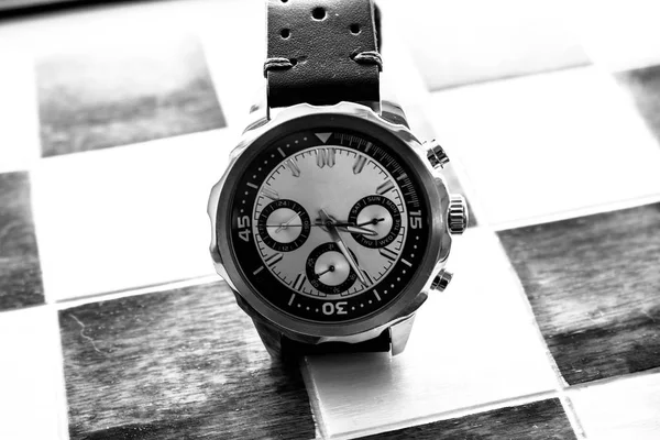 Black and white wrist man watch showing time