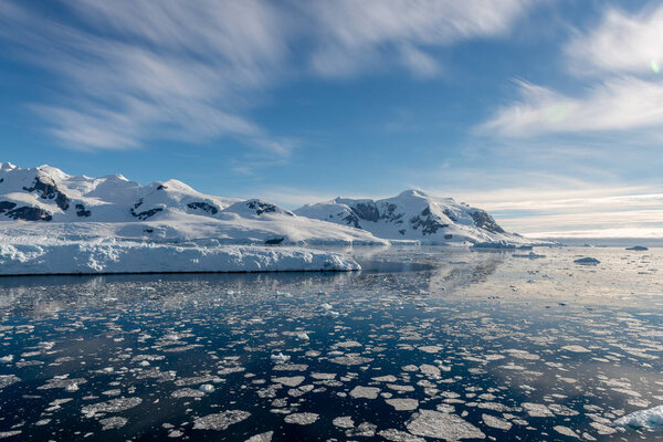 Antarctic seascape with icebergs and reflection