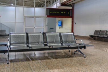 Passenger seats in Departure lounge in airport terminal, travel concept