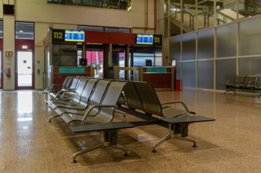 Passenger seats in Departure lounge in airport terminal, travel concept