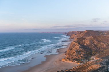Paraglider flying over thesea shore at sunset. Paragliding sport concept.