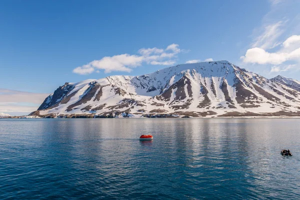 オレンジ色の救命ボートを北極海の水 スヴァールバル諸島に下げます 船の訓練を放棄する 救命艇の訓練 ボードドリルの男 — ストック写真