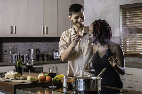 dinner preparation  kitchen cooking happy young mixed race coupl