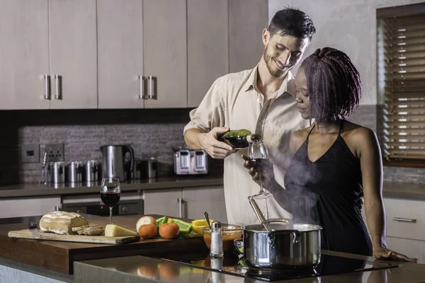 dinner preparation  kitchen cooking happy young mixed race coupl