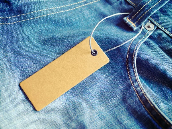 Label price tag mockup on blue jeans.