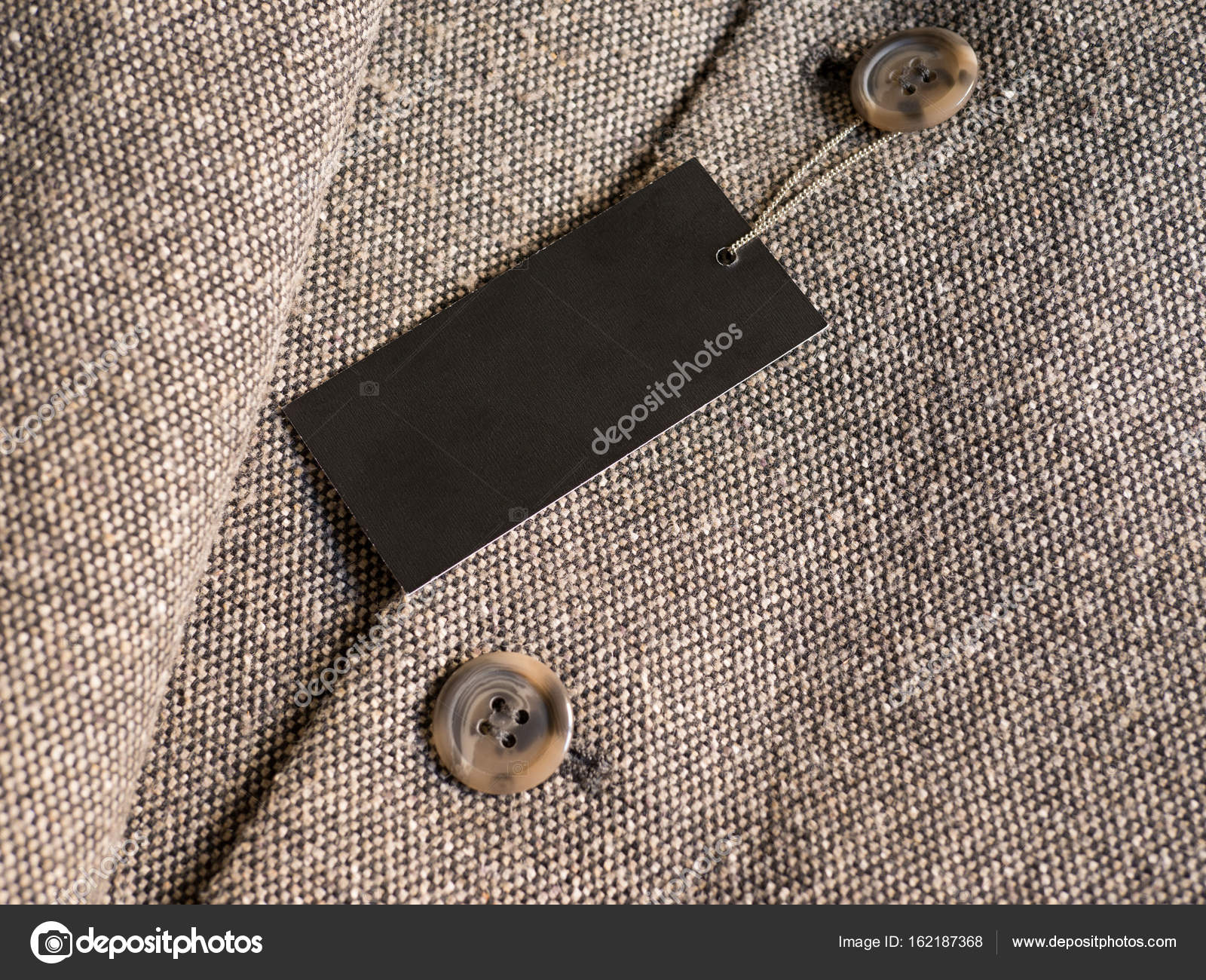 Download Blank black label price tag mockup on brown coat. — Stock Photo © mileswork #162187368